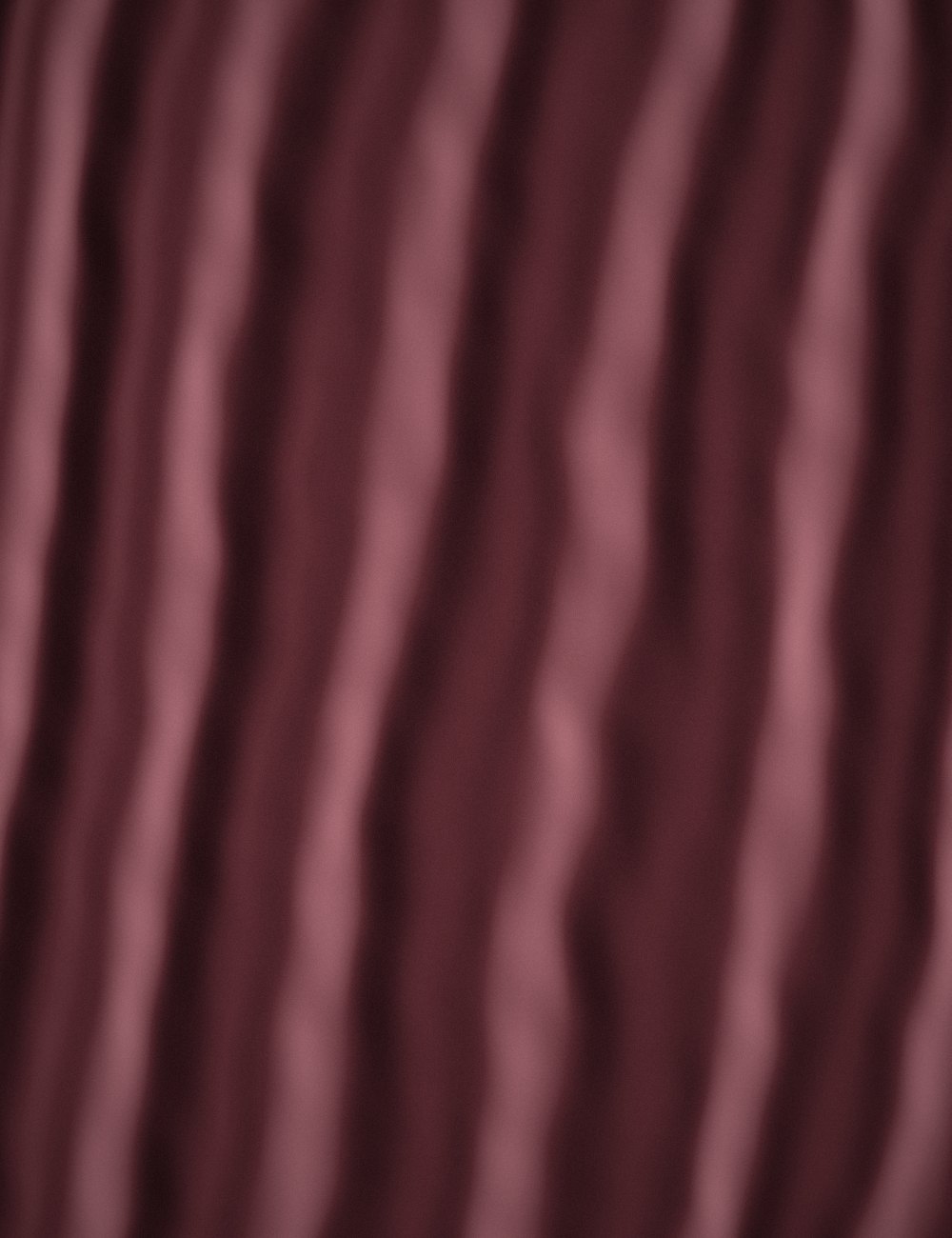 Dusty rose velvet in soft vertical folds.